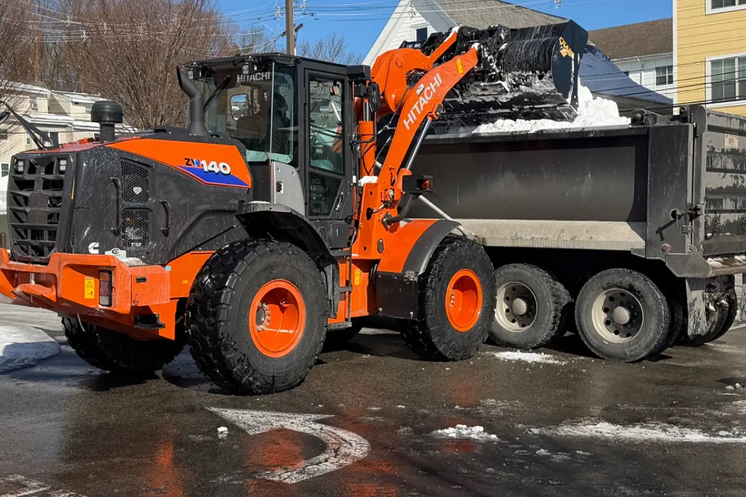 Loading and trucking snow off-site when the piles take over your lot.